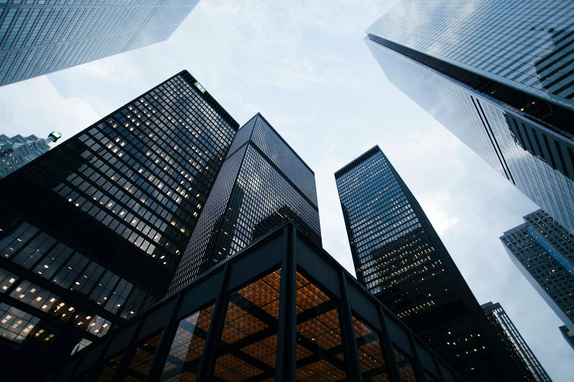 Glass office towers rising against a pale sky