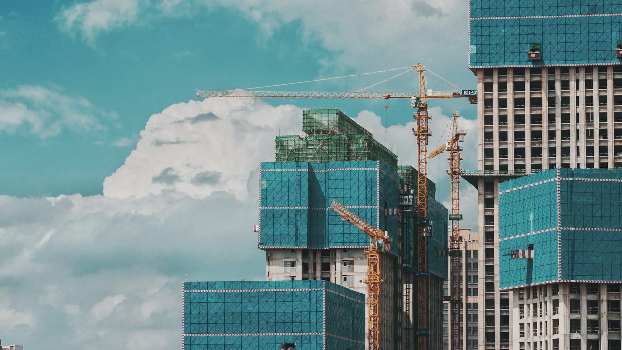 Residential tower under construction with tower cranes